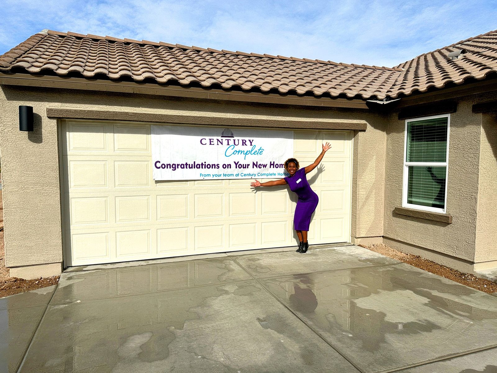 Client celebrating on closing day in front of their new Phoenix home